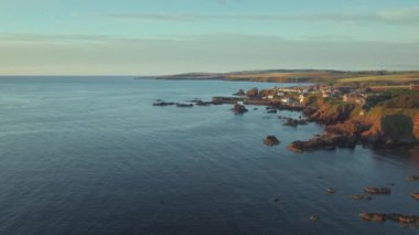 The south east coast of Scotland lit up by the morning sunshine. Video with the panning camera motion. Village of St. Abbs, Starney Bay - Nature Reserve, Berwickshire, Scotland, UK 