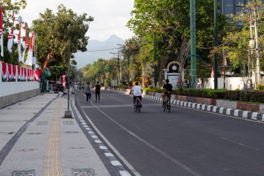 Bir hafta sonu sabah Mataram, Lombok, Endonezya 'da motosiklet ve bisiklete binen çok sayıda insan - 24 Ağustos 2024