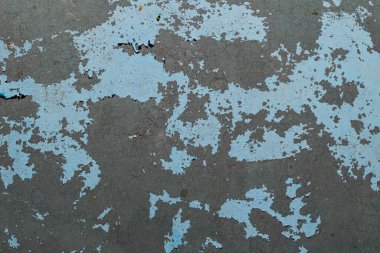 Mavi boya koyu gri yüzey dokusu arkaplanını gösterir.