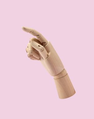 Wooden mannequin hand on pink background. Wooden hand with posture of number 1. Business concept.