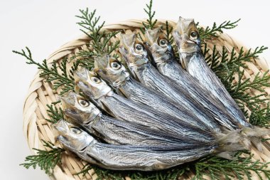 Urume sardines served in a colander placed on a white background. Japanese food, dried fish.