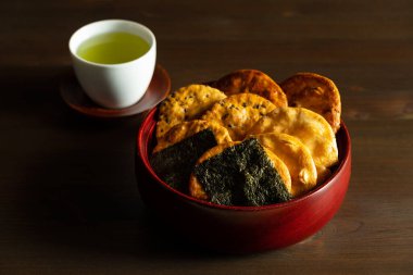 Sembei and green tea on the table. Sembei is a Japanese snack. Japanese image photo.