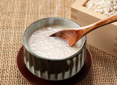 Amazake and a wooden spoon on the table. Amazake is a traditional Japanese sweet drink.