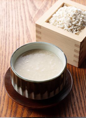 Amazake and rice malt in a Masu box on the table. Amazake is a traditional Japanese sweet drink. Koji is fermented rice.