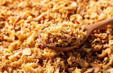 Fried onions and wooden spoons spread across the screen. Crispy fried onions. 