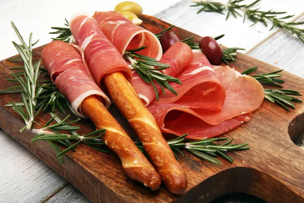 Italian Prosciutto Crudo Jamon Rosemary Raw Ham Appetizer Stock Photo