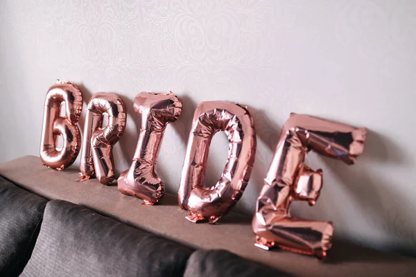 BRIDE - word made from rose gold foil balloons. party or holiday decor concept for bride at home
