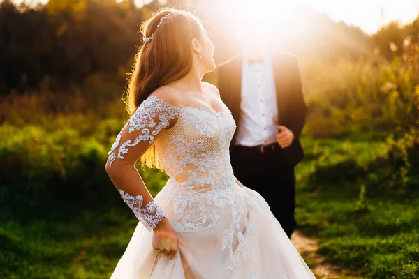 Bride Beautiful Dress Lace Looking Her Shoulder Groom Evening Sunshine — Stock Photo, Image