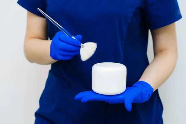 Hands Female Cosmetologist Blue Uniform Blue Rubber Gloves Holds Jar — Stock Photo, Image