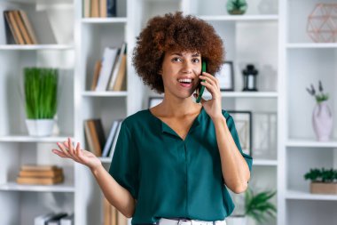 Gülümseyen siyah iş kadını yöneticisi iş yerinde iş görüşmesi yapma telefonda konuşurken, mutlu kadın afro-amerikan yönetici mobil konuşma modern ofis alanında mobil müşteri danışın sahip