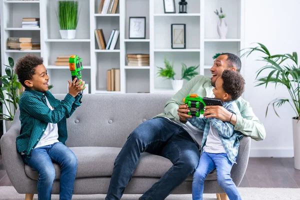 Man Laughing While Playing Sons Sofa — Stock Photo, Image