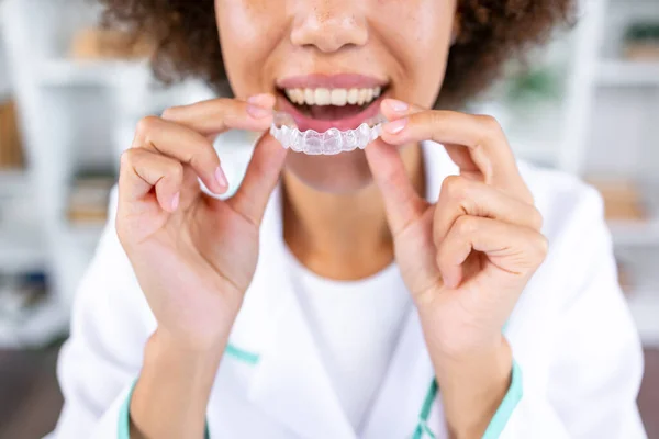 Woman with perfect smile wearing invisible dental aligners for dental correction