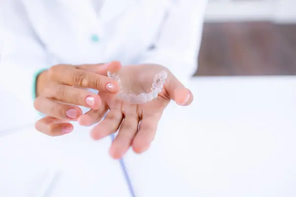 Woman Hand Wearing Medical Uniform Holding Invisible Aligner Ready Use — Stock Photo, Image
