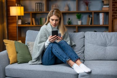 Full length photo of frustrated girl coronavirus infection patient sit couch suffer high temperature hold antipyretic medication.
