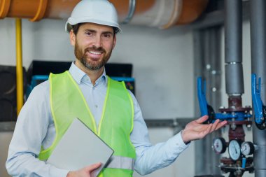Portrait of smiling engineer working in boiler room, factory industrial manufacture, maintenance concept