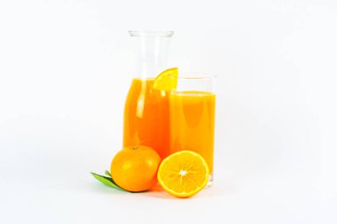 Glass of orange juice with bottle and fresh orange.