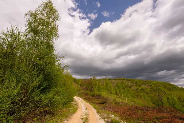 stock image Country road and beautiful cloudscape in remote rural area in Eastern Europe