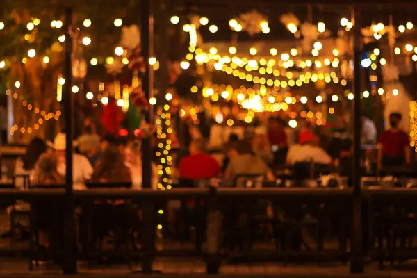 blur image of night festival in a restaurant and The atmosphere is happy and relaxing with bokeh for background