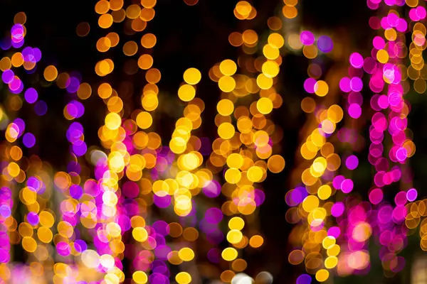 Blur - bokeh Decorative outdoor string lights hanging on tree in the garden at night time - decorative Christmas lights - happy new year