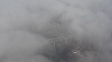 Petrovsky railway bridge over the Dnieper River, Ukraine, Kyiv city. Drone video. Autumn. Fog. 