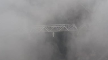Petrovsky railway bridge over the Dnieper River, Ukraine, Kyiv city. Drone video. Autumn. Fog. 