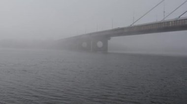 Aerial drone view View Of North or Moscow Bridge Kiev. Ukraine over Dnieper. City view. Traffic on the bridge. Fog.