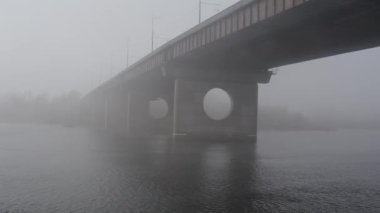 Aerial drone view View Of North or Moscow Bridge Kiev. Ukraine over Dnieper. City view. Traffic on the bridge. Fog.