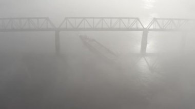Petrovsky railway bridge over the Dnieper River, Ukraine, Kyiv city. Drone video. Autumn. Fog. 