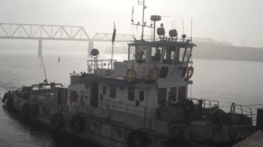 Cargo barge floats on the river, morning haze, fog over the water. Cinematic drone footage. Kyiv. Ukraine. Dnipro river.