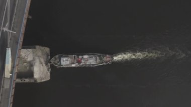 Cargo barge floats on the river, morning haze, fog over the water. Cinematic drone footage. Kyiv. Ukraine. Dnipro river.
