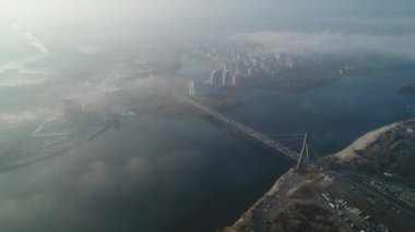 Aerial drone view View Of North or Moscow Bridge Kiev. Ukraine over Dnieper. City view. Traffic on the bridge. Fog.