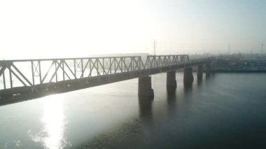 Petrovsky railway bridge over the Dnieper River, Ukraine, Kyiv city. Drone video. Autumn. Fog. 