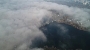 Petrovsky railway bridge over the Dnieper River, Ukraine, Kyiv city. Drone video. Autumn. Fog. 