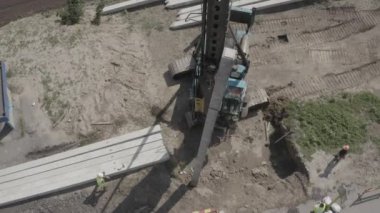 Pile driving machine driving piles into ground site. Modern hydraulic lifting mechanisms. Ukraine. 