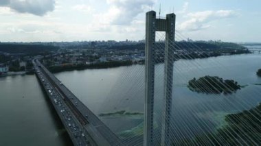 Aerial survey of the south bridge in Kyiv through the Dnieper. Ukraine. Summer. Warm morning.