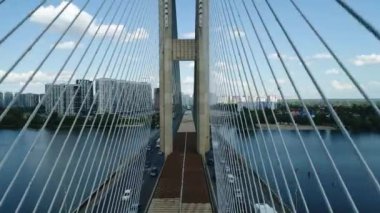 Aerial survey of the south bridge in Kyiv through the Dnieper. Ukraine. Summer. Warm morning.