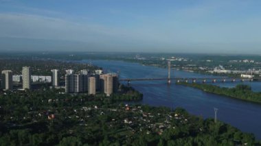 Aerial survey of the south bridge in Kyiv through the Dnieper. Ukraine. Summer. Warm morning.