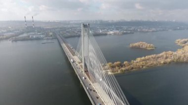 South bridge across the Dnieper in Kiev. Ukraine. Video from drone Traffic. The movement of cars and trains on the bridge. Metro. View under the bridge. Autumn. 