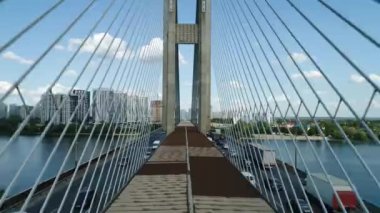 Aerial survey of the south bridge in Kyiv through the Dnieper. Ukraine. Summer. Warm morning.