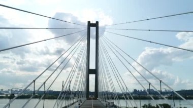 Aerial survey of the south bridge in Kyiv through the Dnieper. Ukraine. Summer. Warm morning.