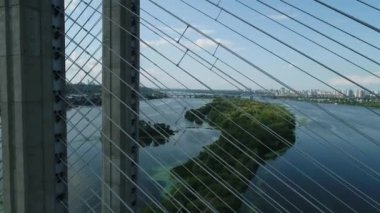 Aerial survey of the south bridge in Kyiv through the Dnieper. Ukraine. Summer. Warm morning.