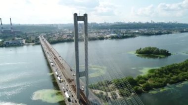 Aerial survey of the south bridge in Kyiv through the Dnieper. Ukraine. Summer. Warm morning.