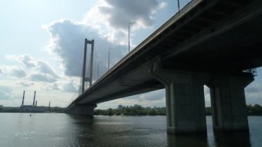 Aerial survey of the south bridge in Kyiv through the Dnieper. Ukraine. Summer. Warm morning.
