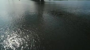 Aerial survey of the south bridge in Kyiv through the Dnieper. Ukraine. Summer. Warm morning.