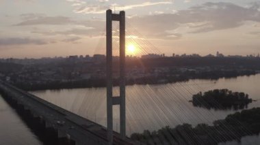 Sunset over the Dnieper river. South bridge. Peak hour. Aerial. Kyiv. Ukraine. Summer. 