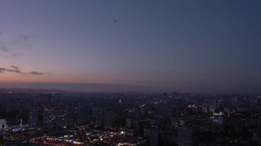 Airplane landing at night in the city of Kyiv. Ukraine. Peak hour. City lights. Summer. Aerial photography.