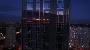 Teremk area after sunset. Sky reflection. Silhouettes of houses. Ukraine. Kyiv. Aerial. City lights. Night. 