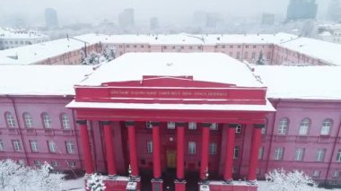 Aerial view of Kyiv Taras Shevchenko National University in winter, against the backdrop of the snow-capped capital. nowy and frosty weather
