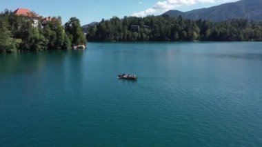 Gölün ortasındaki Mary Varsayımı Kilisesi Bled. Slovenya. Havadan. Yaz. İnsansız hava aracı videosu. Bled Gölü 'nde küçük bir adada uçmak. Mavi su ve orman..