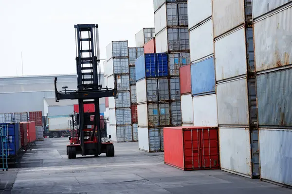 Industrial logistics transport forklift truck transport container box loading stacker at port to truck for shipping export and import trade goods at port of freight